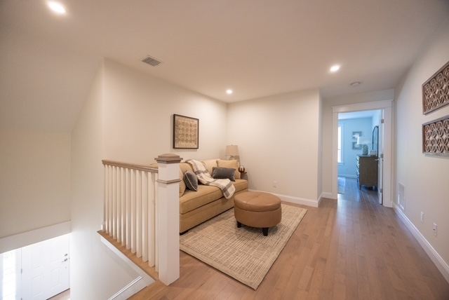 Second-floor loft sitting area in a duplex-style 55+ condominium at Trailside Estates Rochester MA — flexible space for guests or hobbies